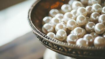 Close-up of lustrous pearls in an ornate antique bowl. photo