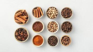 Assorted spices in bowls cinnamon, cloves, star anise, cocoa, turmeric, job's tears. photo