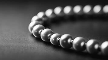Close-up of a pearl necklace on a dark background. photo