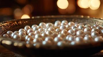 Close-up of lustrous pearls in an ornate bowl. photo
