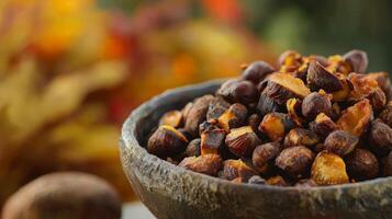 Roasted chestnuts in a rustic bowl, autumnal background. photo
