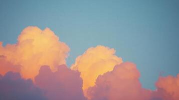 Sunset cloudscape, vibrant orange and pink hues illuminate fluffy cumulus clouds against a soft blue sky. photo