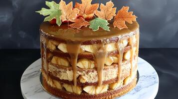 Caramel apple cake with autumn leaves decoration. photo