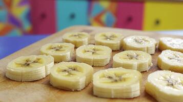 Sliced bananas arranged on a wooden board. photo