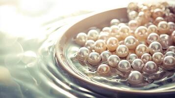Lustrous pearls in a bowl of water. photo