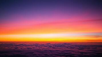 Aerial view of vibrant sunset over a sea of clouds. photo