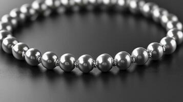 Close-up of a silver pearl bracelet on a dark background. photo