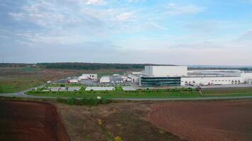 Contemporary farm on nature background. White architecture of industrial plant near the highway. Innovative factory on field. Motion camera to the right. video