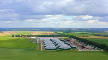 Modern biogas plant in summer. Greenhouse complex for biogas production among green nature. Pollution the environment. Aerial view. video