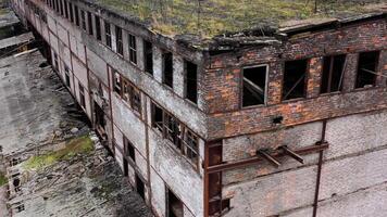 Ruined architecture after military actions. Abandoned building with broken windows and many hole in walls. Damaged building outdoors. Aerial view. video