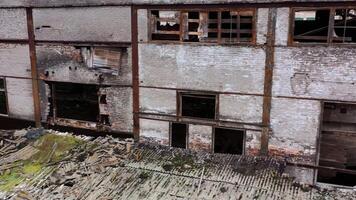 Damaged building with broken windows. Abandoned place after the war. Exterior of empty building during military actions. video