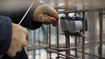 Worker Securing Electrical Box to Rebar Framework video