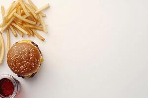 A hamburger and french fries on a white surface photo