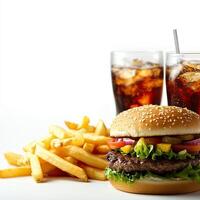 A hamburger and fries on a white table photo