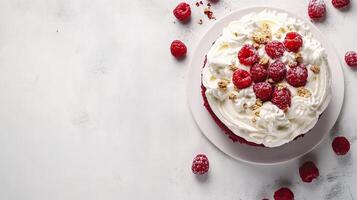 A white cake with whipped cream and raspberries photo