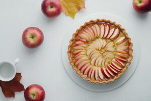 An apple pie with slices of apples on a white plate photo