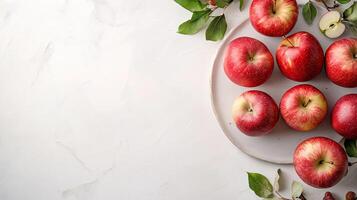 Fresh red apples on a white plate photo