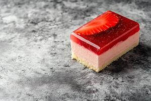 A piece of strawberry cake with a strawberry on top photo