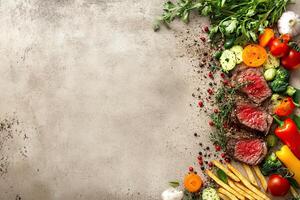 Fresh vegetables and meat on a concrete background photo