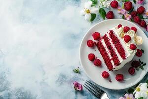 A piece of red velvet cake with raspberries on a white plate photo