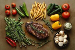 Steak, vegetables and mushrooms on a table photo