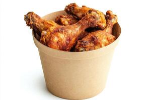 A brown paper cup filled with chicken wings photo