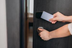 Electronic card key for open door in hotel. Smart card key to lock and unlock door. Security systems concept. photo
