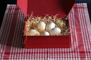 Red Box With Straw And Eggs photo