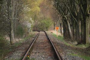 Rail track with orange number one sign, narrow field of view. photo