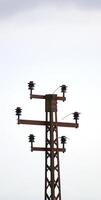 Obsolete power pole without cables. photo