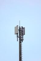 Top of telecommuncations tower and blue sky. photo