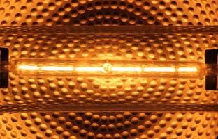 Halogen tube lamp with reflecting metal background photo