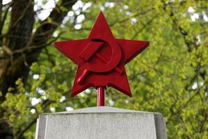 Red star with hammer and sickle, a memorial for the fallen russian soldiers in WWII, on a cemetary in Greifswald, Germany photo