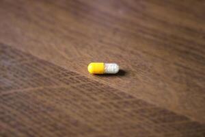 Pill on a wooden background. photo