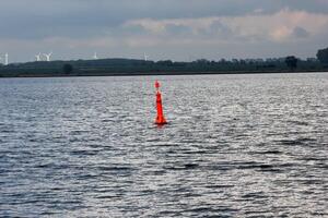Red buoy on a clouded day on the Greifswalder Bodden, Mecklenburg-Vorpommern, Germany photo