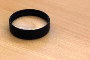 Close up lens on wooden desk. photo