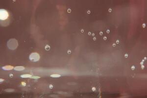 Bubbles and glare on brown background. photo