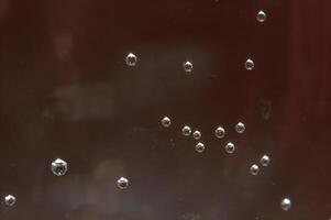 Bubbles and glare on brown background photo