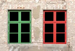 Colorful windows in a dilapidated house. photo
