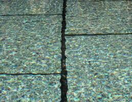 View of a fountain basin with soft waves and reflections usable as background. photo