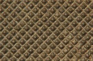 Close-up of a nubby metal surface. photo