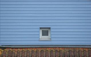Window in blue wooden wall. photo