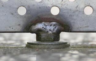 Close up of a weld seam holding metal panel with holes photo