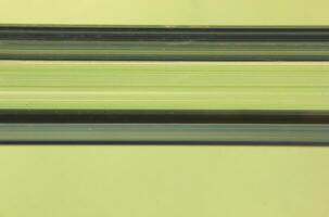 Abstract background from close up of a plastic bar in green light photo