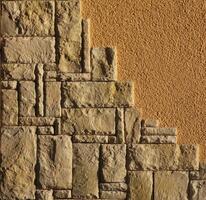 Freestone and standard plaster on a wall. photo