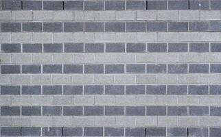 Wall made from rows of white and gray bricks usable as background or texture. photo