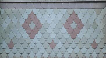 Ornamental roof tiles with patina usable as texture or background. photo