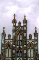 Top of a historic city center building in the style of brick gothic. This architectural style was used from the 12th to the 16th century. The image was created using a HDR imaging technique. photo