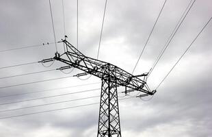 Conceptual shot of the silhouette of a high voltage power line in Mecklenburg-Vorpommern, Germany. photo