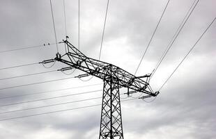 Conceptual shot of the silhouette of a high voltage power line in Mecklenburg-Vorpommern, Germany photo